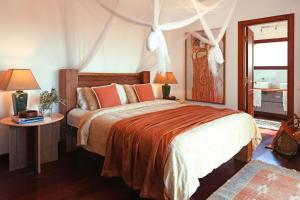 a bedroom with a bed and a table and a window at Casa San Luis in Pájara