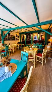 a dining room with tables and chairs in a restaurant at Casa Kuhn in Sighişoara