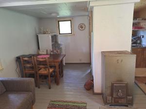 a kitchen and dining room with a table and chairs at Kalliotupa in Haapakylä