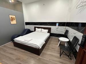 a room with a bed and a table and chairs at Khách Sạn Điểm Hẹn in Ho Chi Minh City