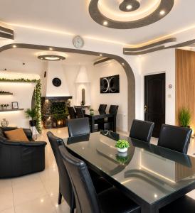 a dining room with a table and chairs and a fireplace at Pensiunea Carina in Bran