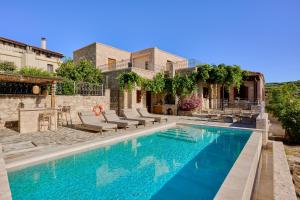 a villa with a swimming pool and a house at Villa Iremia in Nísi