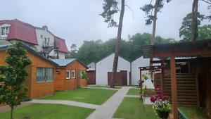 a group of houses with a yard with grass at Domki u Wiki in Niechorze