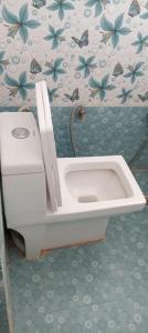 a bathroom with a toilet and a sink at Pragya inn hotel Haldwani in Haldwāni