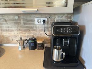a coffee maker on a counter in a kitchen at Stone house Chiara Seaview in Funtana