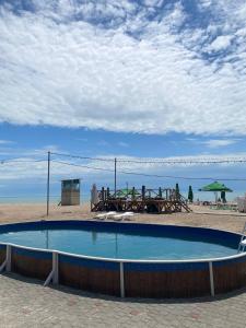 a swimming pool on the beach with a table and chairs at Era Maris in Odesa