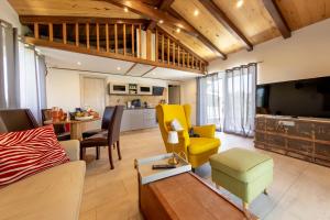 a living room with a couch and chairs and a table at Casa MiA in Linardići