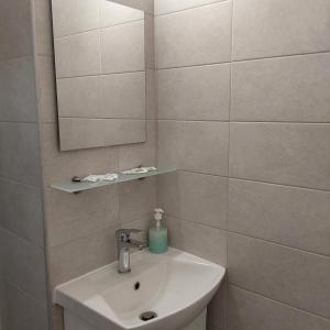 a bathroom with a sink and a mirror at ANNA MARIA Studios in Potos