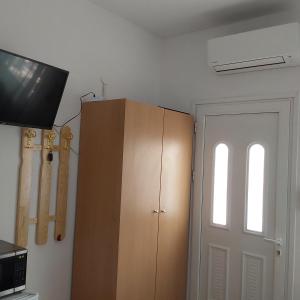 a room with a cabinet and a window and a door at ANNA MARIA Studios in Potos +185 photos