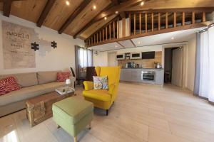 a living room with a couch and a yellow chair at Casa MiA in Linardići