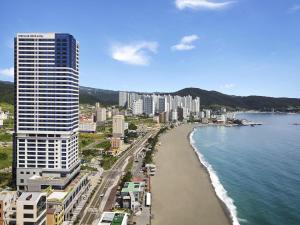 a view of a city with a beach and buildings at Mercure Ambassador Ulsan in Ulsan