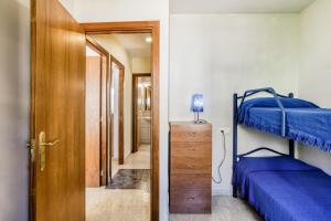 a bedroom with two bunk beds and a doorway at Casa con piscina comunitaria in L'Escala +25 photos