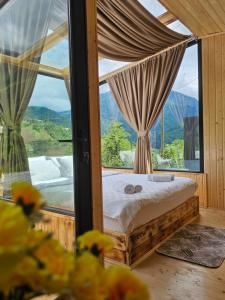 a bedroom with a bed and a large window at Merisi Horizon in K'eda