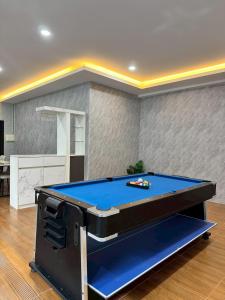 a ping pong table in a living room at Honey Bliss Pool Villa in Hat Yai