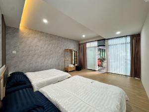 a bedroom with two beds and a large window at Honey Bliss Pool Villa in Hat Yai +33 photos