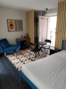 a bedroom with a bed and a table and chairs at Casa Morenica - Cementina in Montalto Dora +7 photos