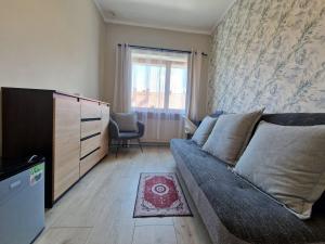 a living room with a couch and a window at Promień 4 by Zen4Guest - Biskupin in Wrocław