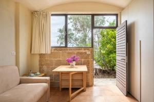 a living room with a table and a window at Residenze Uliveto - Rooms in Nardò