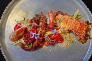 a plate of food with meat and vegetables on it at Hotel Spa Nau Royal in Camburi