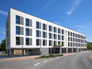 a large white building on the side of a street at B&B HOTEL Wertheim in Wertheim