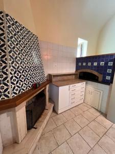 a kitchen with blue and white tiles on the wall at Casa Giordano in Tramonti +20 photos