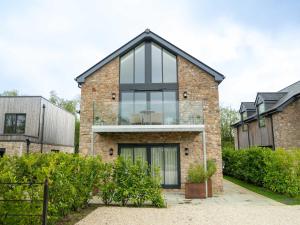 a brick house with large glass windows at Hill View House - Cookswood in Holcombe
