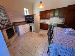 a kitchen with a table and a counter top at Casa Giordano in Tramonti