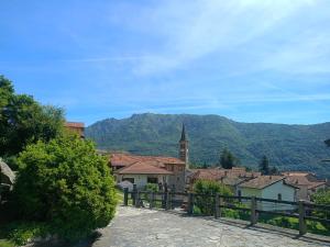 a view of a town with a church and a mountain at Casa Silvia Natura Relax, Sport & Family in Omegna