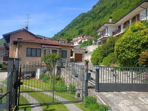 a gate in front of a house with a mountain at Casa Silvia Natura Relax, Sport & Family in Omegna