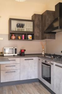 a kitchen with stainless steel cabinets and a microwave at Mare di Gioia in Viareggio