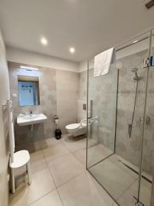 a bathroom with a shower and a toilet and a sink at Erhardt Panzió in Sopron +47 photos