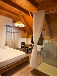 a bedroom with a bed and a desk and a window at Hotel - Resort Vellezerit Doka in Klos