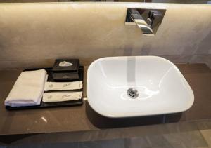 a white sink on a counter in a bathroom at Hotel Fortune Plaza in Karnal
