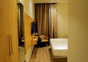 a bedroom with a bed and a desk and a tv at Hotel Fortune Plaza in Karnal