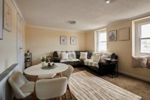 a living room with a couch and a table at Host & Stay - Cobblers Cottage in Whitby +13 photos