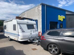 a silver car parked in front of a trailer at Hobby De Luxe Caravan in Copenhagen +2 photos
