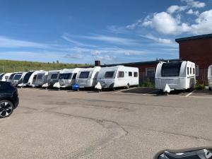 a row of rvs parked in a parking lot at Hobby De Luxe Caravan in Copenhagen