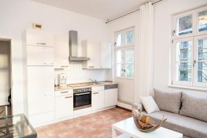 a living room with a couch and a kitchen at Villa Elise in Bad Schandau