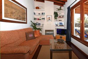 a living room with a couch and a table at Casa Simbad in Pájara