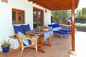 a patio with a table and chairs on a patio at Casa Simbad in Pájara
