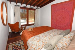 a bedroom with a bed and a chair and a window at Casa Simbad in Pájara +8 photos