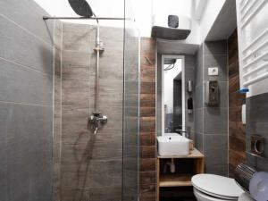 a bathroom with a shower with a toilet and a sink at Silver Gate Rooms-Diocletian's Palace in Split +25 photos