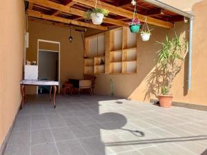 a patio of a house with a table and potted plants at Silver Gate Rooms-Diocletian's Palace in Split