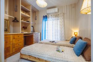 a bedroom with two beds with blue pillows at Savoy Signature Stays in Il-Gżira
