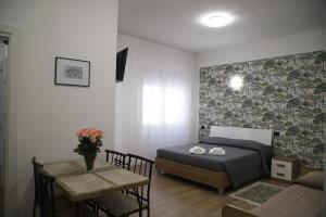 a bedroom with a bed and a table in a room at La Torretta in Savona