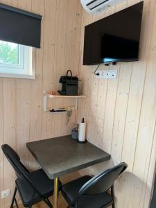 a table and chairs in a tiny house at Svala Guesthouses in Selfoss
