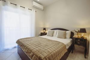 a bedroom with a large bed and a window at Savoy Signature Stays in Il-Gżira
