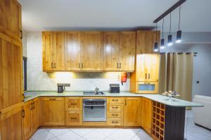 a kitchen with wooden cabinets and a sink at Savoy Signature Stays in Il-Gżira