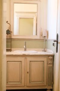 a bathroom with a sink and a mirror at Mare di Gioia in Viareggio +11 photos
