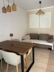 a living room with a table and a couch at Apartma Ložice in Deskle